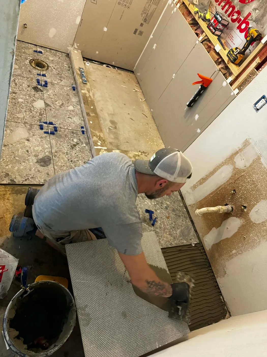 John McNatt prepping a bathroom floor for tile